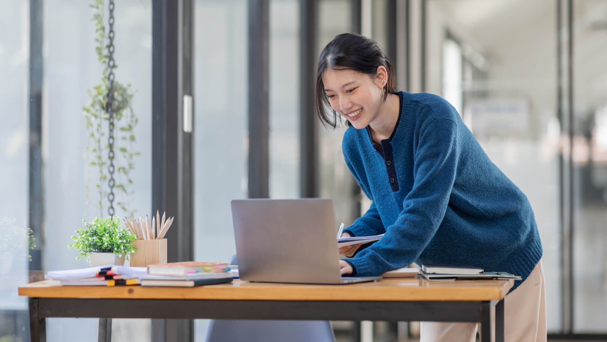 business-asian-woman-using-laptop-computer-and-working-at-office-with-calculator-document-on-desk-.jpg